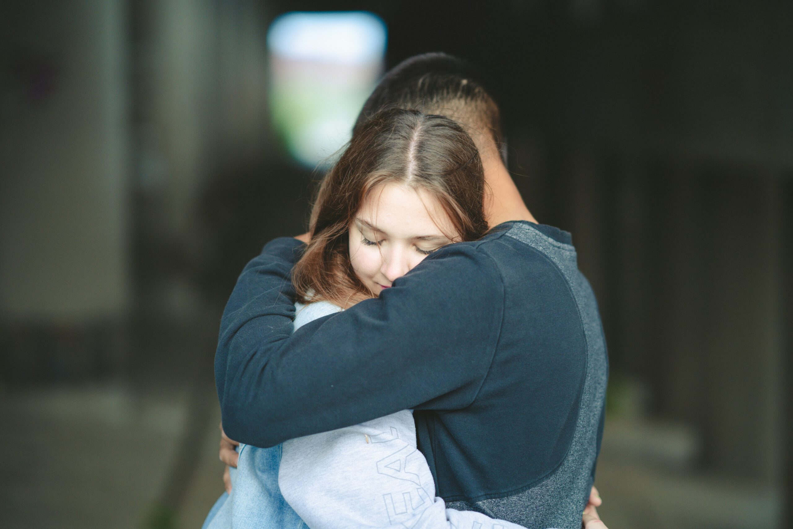 a couple of people that are hugging each other